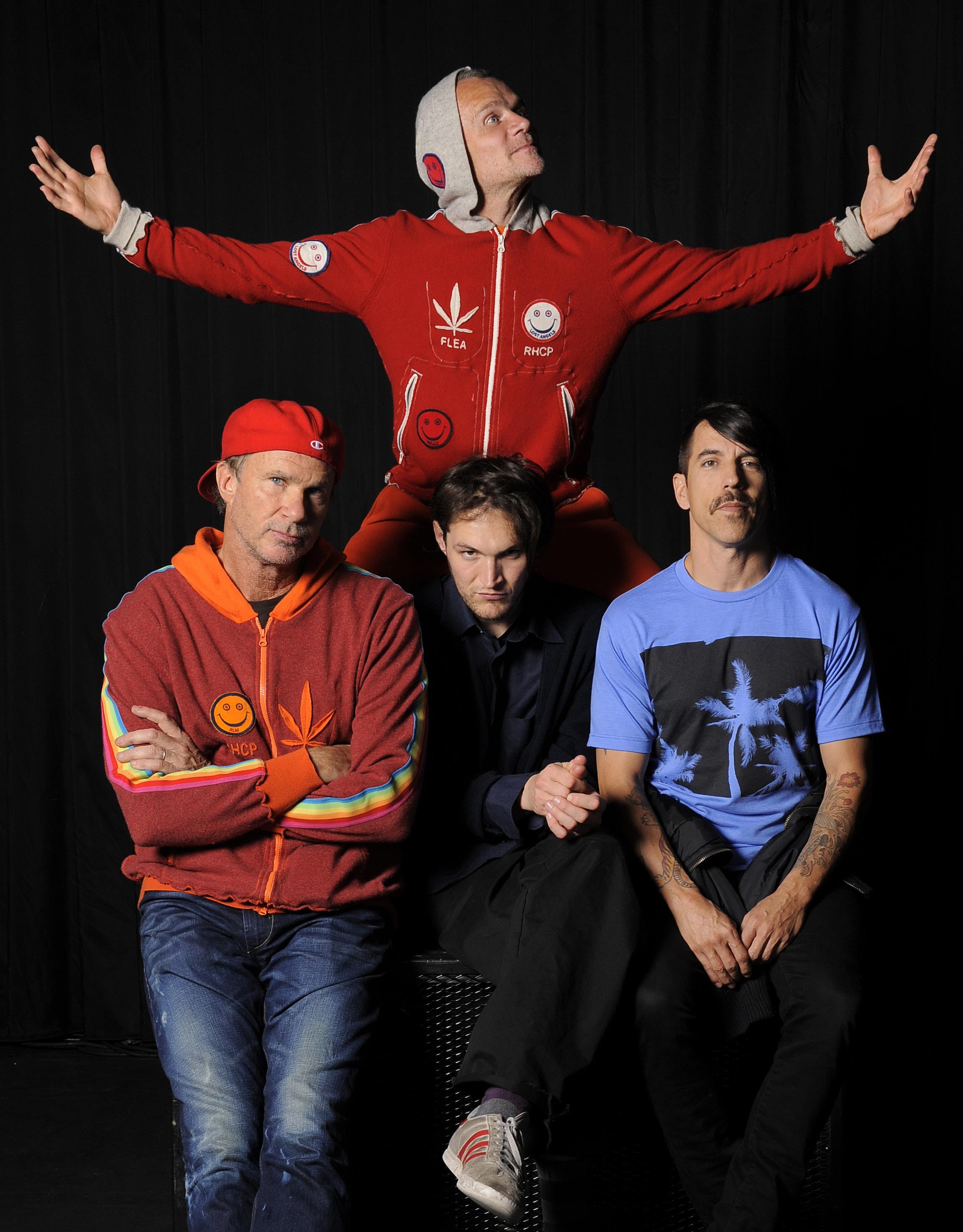 Chef placing cheese on raw pizza bread